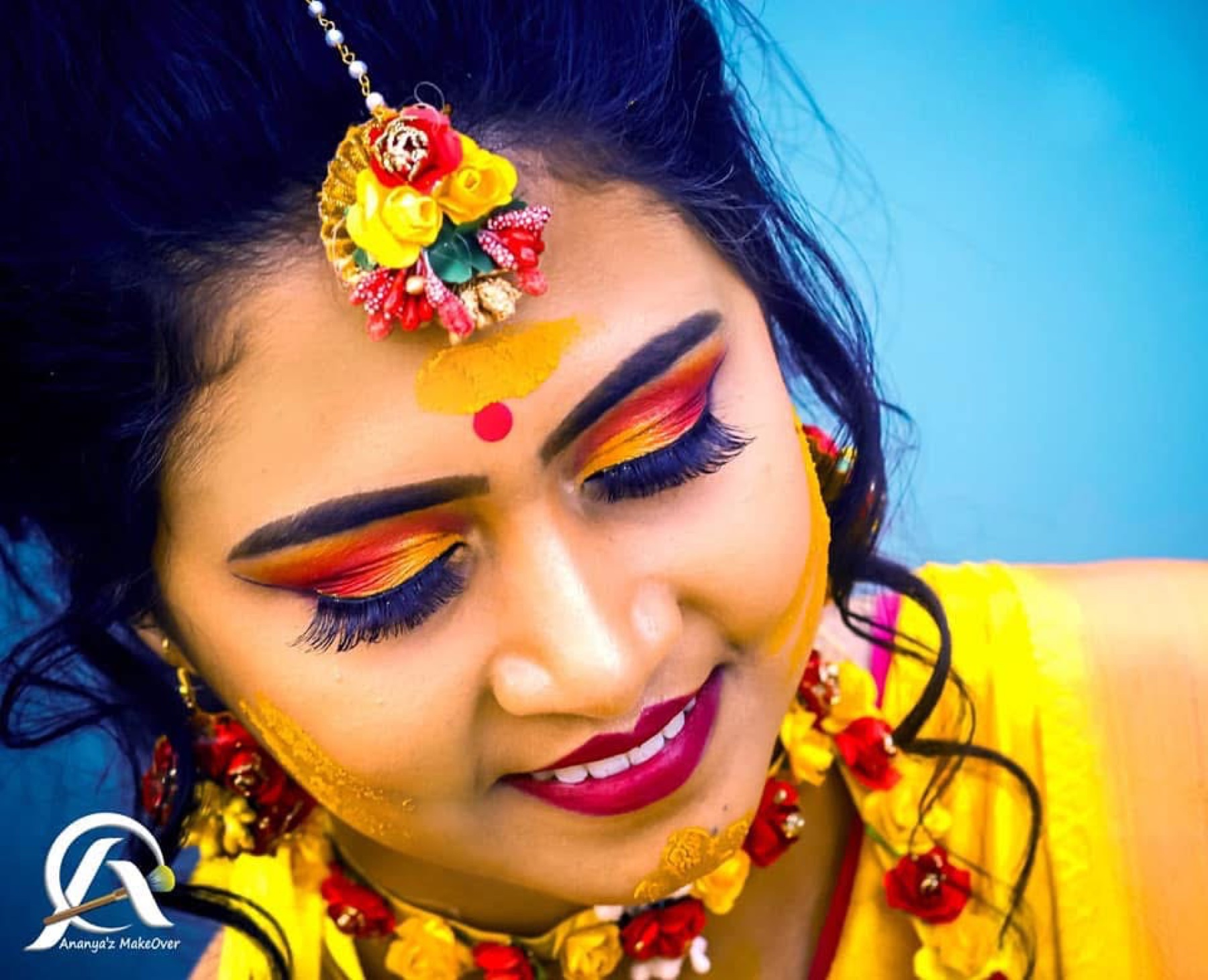 Bright haldi makeup with warm sunset eyes, floral jewellery and a yellow outfit
