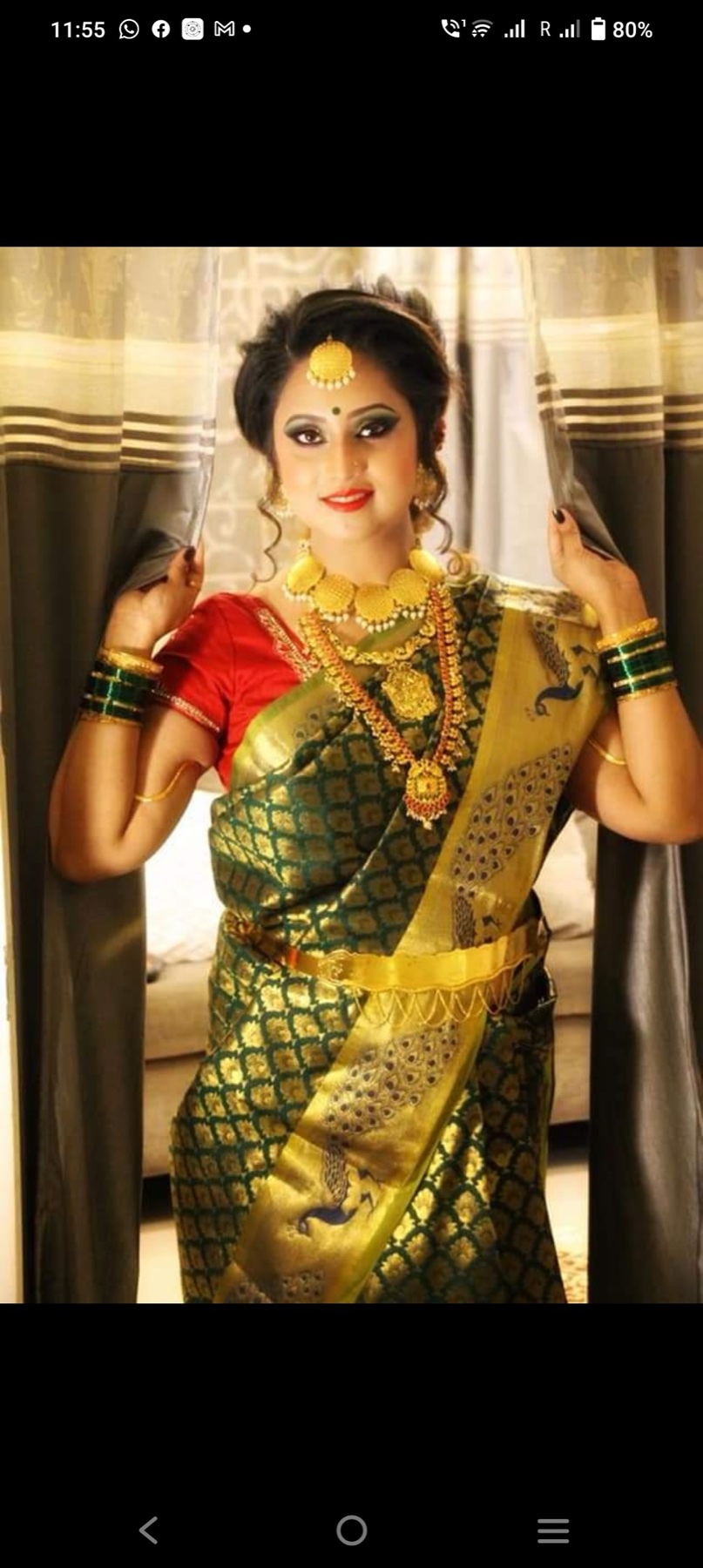 Traditional green and gold saree look with dramatic eyes and an elegant updo