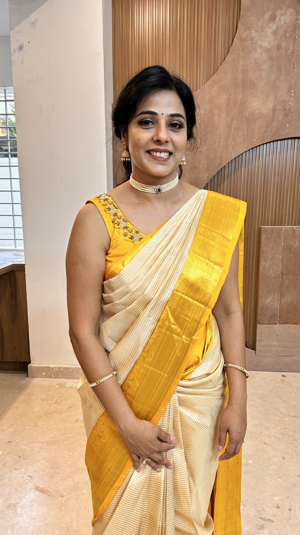 Polished bridal makeup with softly sculpted skin and traditional jewellery