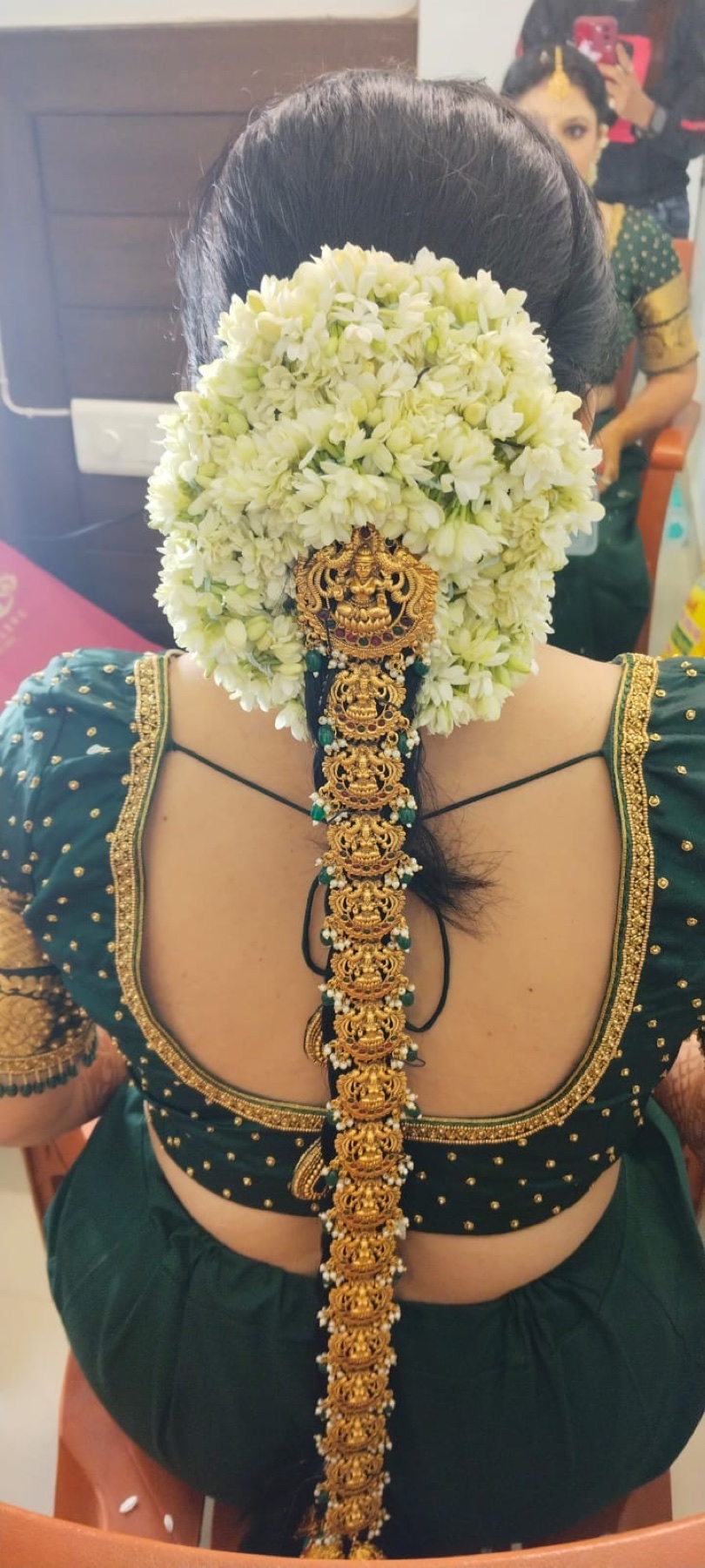 Traditional bridal braid decorated with jasmine flowers and temple jewellery
